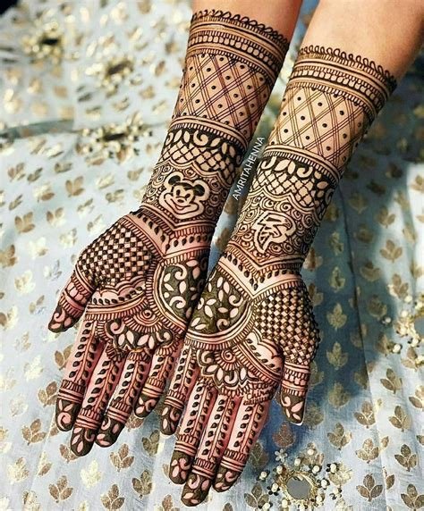 14_Indian Groom And Bride At Mehendi Ceremony Showing Designs Bride